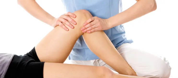 Physical therapist performing manual therapy on a knee